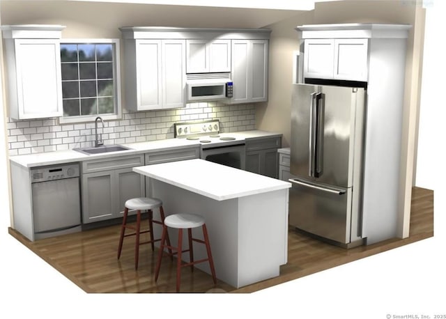 1069 N Colony Rd, Meriden, CT 06450 - kitchen featuring stainless steel appliances, a kitchen bar, decorative backsplash, dark wood-style floors, and a center island