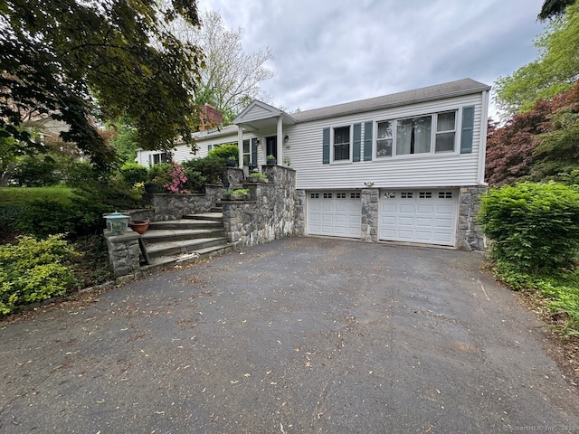 48 Bailey St, Trumbull, CT 06611 - view of front of property featuring driveway, stone siding, and an attached garage
