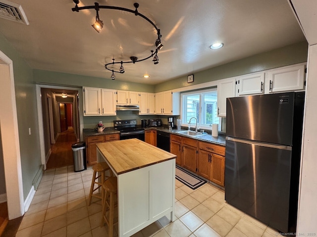 48 Bailey St, Trumbull, CT 06611 - kitchen with black appliances, a sink, wooden counters, under cabinet range hood, and light tile patterned flooring
