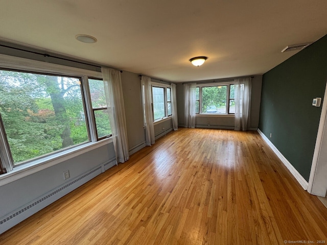 48 Bailey St, Trumbull, CT 06611 - spare room with baseboard heating, light wood finished floors, and baseboards