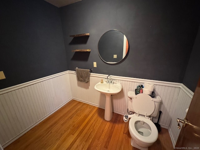 48 Bailey St, Trumbull, CT 06611 - bathroom with a wainscoted wall, wood finished floors, toilet, and a sink