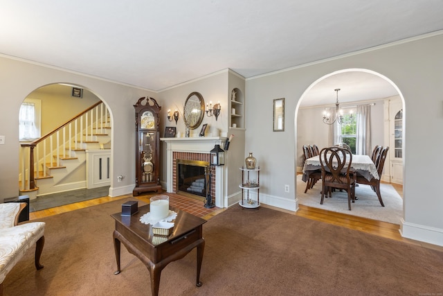 8 Usher Ave, Plainville, CT 06062 - living room with crown molding, wood finished floors, a chandelier, stairway, and arched walkways