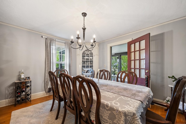 8 Usher Ave, Plainville, CT 06062 - dining area featuring a chandelier, ornamental molding, healthy amount of natural light, wood finished floors, and baseboards