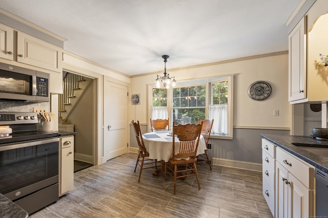 8 Usher Ave, Plainville, CT 06062 - dining area featuring a chandelier, stairs, baseboards, wood finished floors, and crown molding