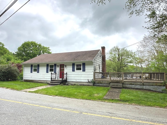 331 Pond Hill Rd, Plainfield, CT 06354 - view of front of home featuring a chimney, a front lawn, a wooden deck, and a shingled roof