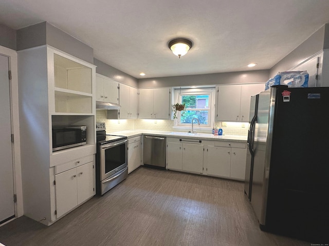 331 Pond Hill Rd, Plainfield, CT 06354 - kitchen featuring appliances with stainless steel finishes, under cabinet range hood, wood finished floors, a sink, and light countertops