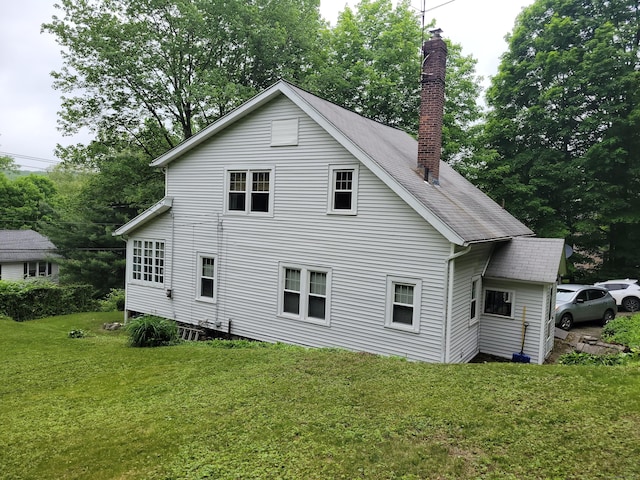 706 Waterville St, Waterbury, CT 06710 - back of property with a chimney, a yard, and view of wooded area