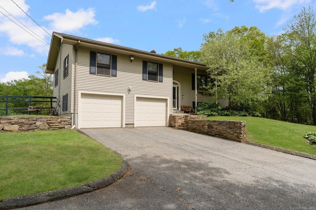 232 Bailey Hill Rd, Killingly, CT 06239 - raised ranch with asphalt driveway, a garage, and a front lawn