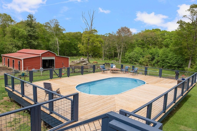 232 Bailey Hill Rd, Killingly, CT 06239 - view of pool with a deck, a pole building, an outbuilding, and a forest view