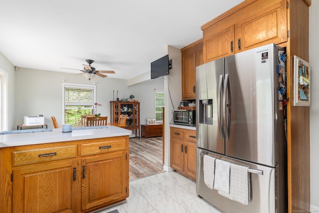 232 Bailey Hill Rd, Killingly, CT 06239 - kitchen with stainless steel refrigerator with ice dispenser, light countertops, ceiling fan, and brown cabinets
