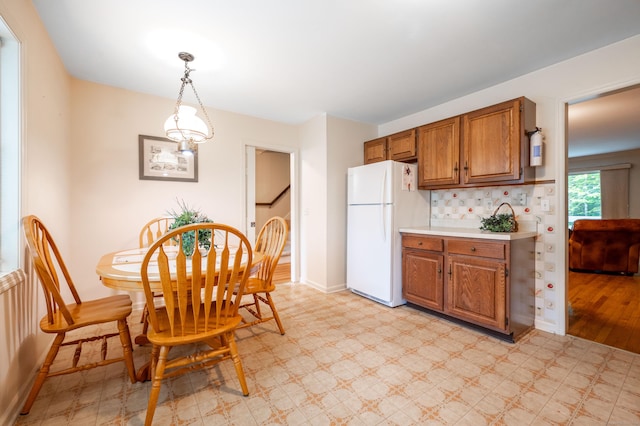 5 Bridgewater Cmn Unit 5, Bridgewater, CT 06752 - kitchen with freestanding refrigerator, light floors, light countertops, brown cabinets, and baseboards