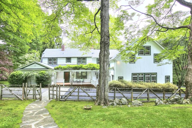 481 Ridgefield Rd, Wilton, CT 06897 - back of property featuring a gate, a chimney, and covered porch