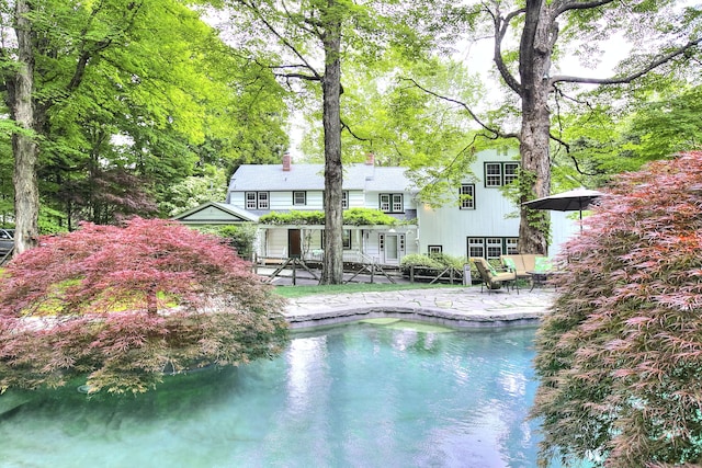 481 Ridgefield Rd, Wilton, CT 06897 - rear view of property featuring a patio area, an outdoor pool, and a chimney