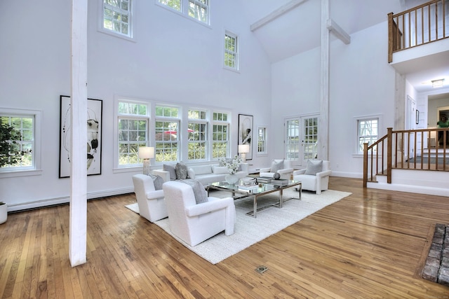 481 Ridgefield Rd, Wilton, CT 06897 - living area with a towering ceiling, hardwood / wood-style flooring, stairway, healthy amount of natural light, and baseboards