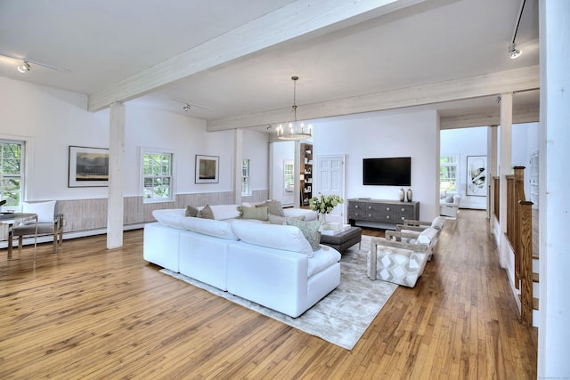 481 Ridgefield Rd, Wilton, CT 06897 - living room with track lighting, beamed ceiling, wood finished floors, a chandelier, and baseboard heating