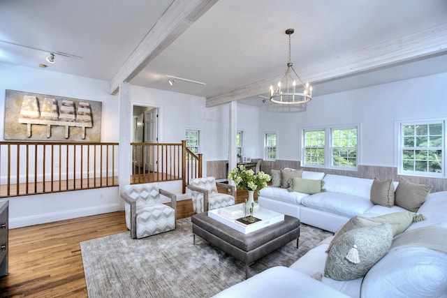 481 Ridgefield Rd, Wilton, CT 06897 - living room with a chandelier, wood finished floors, beamed ceiling, baseboards, and wainscoting