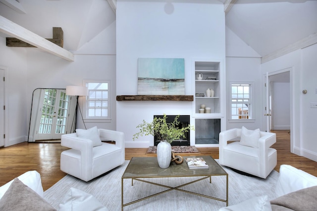481 Ridgefield Rd, Wilton, CT 06897 - living room with high vaulted ceiling, wood finished floors, baseboards, and built in features