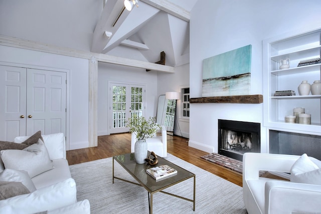 481 Ridgefield Rd, Wilton, CT 06897 - living area with wood finished floors, a fireplace, beamed ceiling, baseboards, and french doors