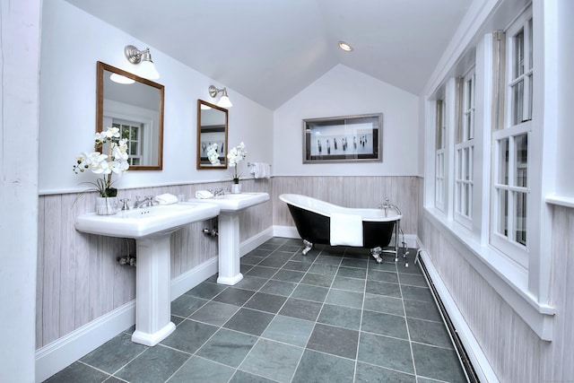 481 Ridgefield Rd, Wilton, CT 06897 - bathroom featuring a freestanding tub, vaulted ceiling, wainscoting, a baseboard heating unit, and tile patterned floors