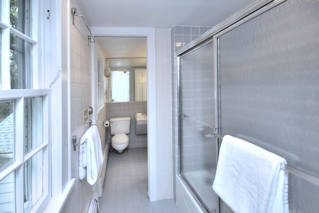 481 Ridgefield Rd, Wilton, CT 06897 - bathroom featuring tile walls, tile patterned flooring, toilet, combined bath / shower with glass door, and baseboard heating