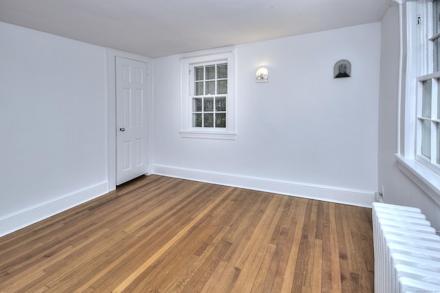 481 Ridgefield Rd, Wilton, CT 06897 - unfurnished room featuring radiator heating unit, wood finished floors, and baseboards
