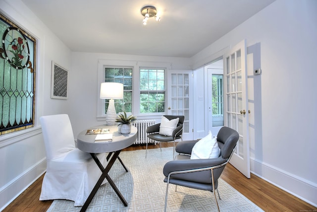 481 Ridgefield Rd, Wilton, CT 06897 - dining area featuring radiator, baseboards, and wood finished floors
