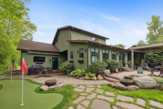 23 Blackhaw Dr, Cromwell, CT 06416 - back of property featuring a patio area, a putting area, an outdoor fire pit, and entry steps
