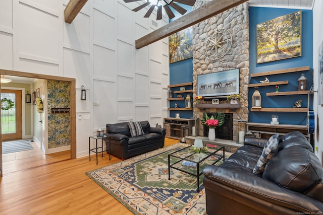 23 Blackhaw Dr, Cromwell, CT 06416 - living area with ceiling fan, light wood-type flooring, a fireplace, baseboards, and a towering ceiling