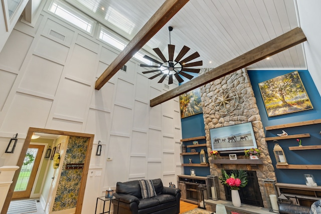 23 Blackhaw Dr, Cromwell, CT 06416 - living room featuring a stone fireplace, high vaulted ceiling, beam ceiling, a decorative wall, and a ceiling fan