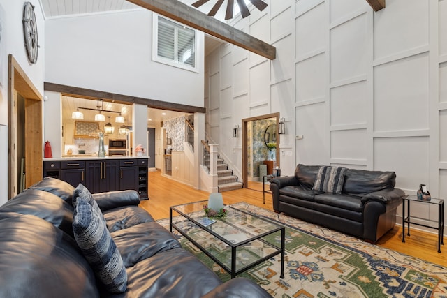 23 Blackhaw Dr, Cromwell, CT 06416 - living area featuring high vaulted ceiling, light wood-type flooring, a ceiling fan, and stairs