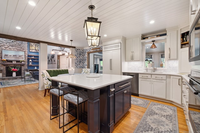 23 Blackhaw Dr, Cromwell, CT 06416 - kitchen featuring a sink, dishwasher, white cabinets, a kitchen bar, and wooden ceiling