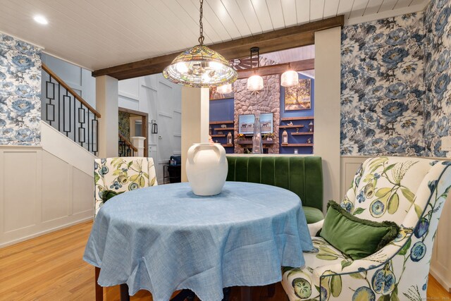 23 Blackhaw Dr, Cromwell, CT 06416 - dining space featuring a decorative wall, wood finished floors, stairs, a wainscoted wall, and wood ceiling with exposed beams