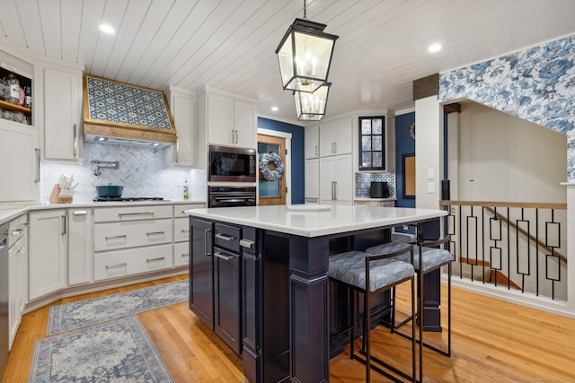 23 Blackhaw Dr, Cromwell, CT 06416 - kitchen featuring black oven, custom range hood, built in microwave, white cabinetry, and wood ceiling