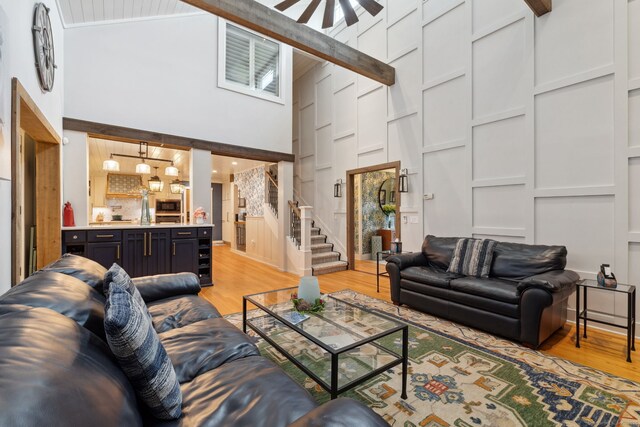 23 Blackhaw Dr, Cromwell, CT 06416 - living area featuring high vaulted ceiling, light wood-type flooring, a ceiling fan, and stairs