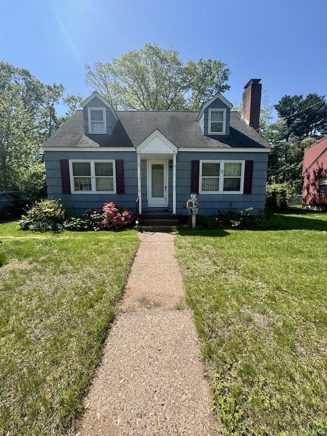 710 Middle Tpke W, Manchester, CT 06040 - view of front of home with a chimney and a front yard
