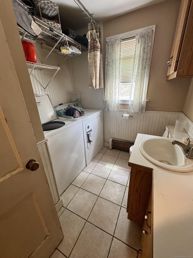 710 Middle Tpke W, Manchester, CT 06040 - laundry area featuring washer and clothes dryer, a sink, light tile patterned floors, and a wainscoted wall
