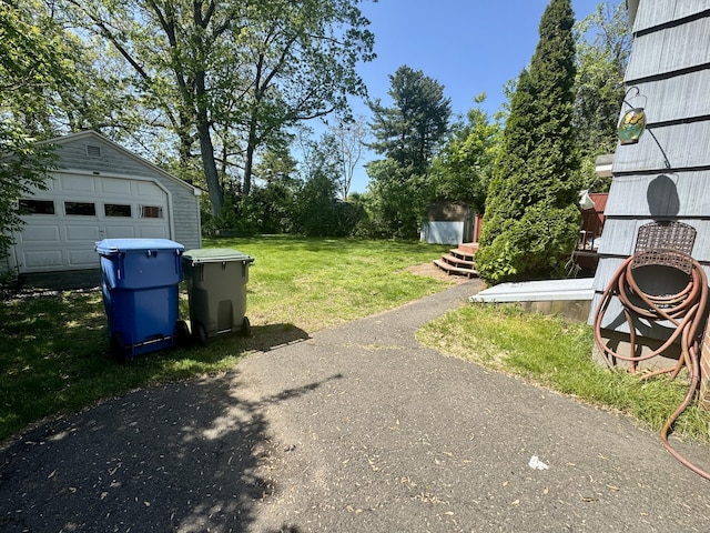710 Middle Tpke W, Manchester, CT 06040 - view of grassy yard with an outdoor structure and a garage