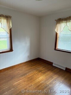 153 Barton St, Torrington, CT 06790 - spare room with wood finished floors and a baseboard radiator