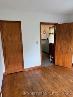 153 Barton St, Torrington, CT 06790 - empty room with wood finished floors and baseboards