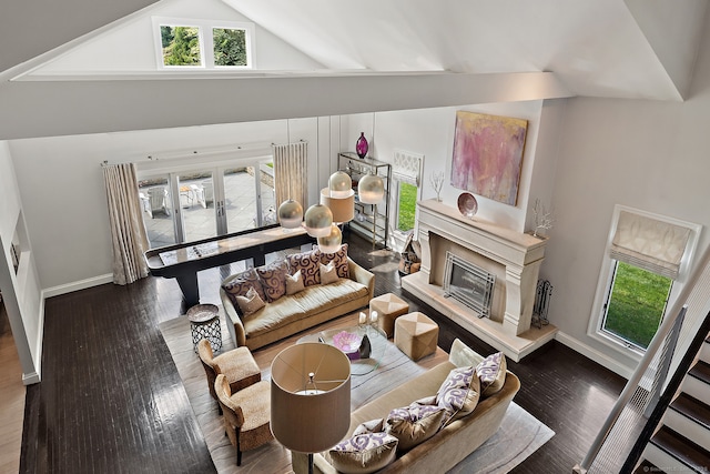 166 Long Lots Rd, Westport, CT 06880 - living room with plenty of natural light, high vaulted ceiling, a high end fireplace, wood finished floors, and french doors