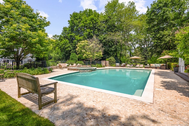166 Long Lots Rd, Westport, CT 06880 - view of swimming pool with a patio area, view of scattered trees, and a pool with connected hot tub