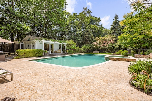 166 Long Lots Rd, Westport, CT 06880 - view of swimming pool featuring a storage structure, a patio area, an outdoor structure, a pool with connected hot tub, and view of wooded area