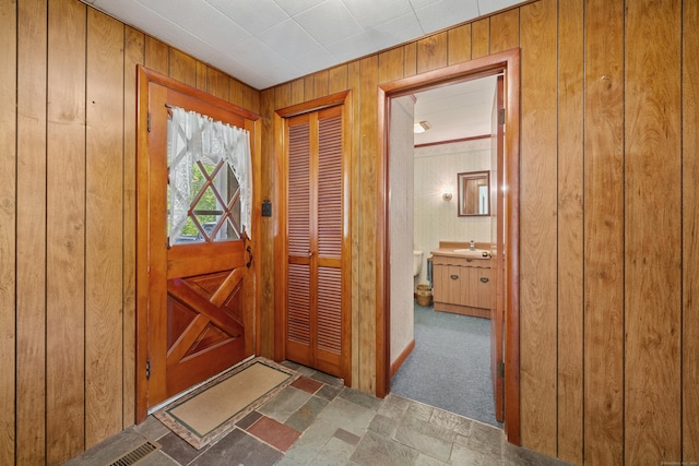 413 Hickory Hill Rd, Thomaston, CT 06787 - foyer entrance with wooden walls and carpet