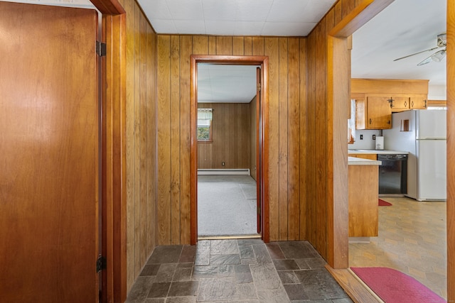 413 Hickory Hill Rd, Thomaston, CT 06787 - corridor featuring baseboard heating, stone finish flooring, and wooden walls
