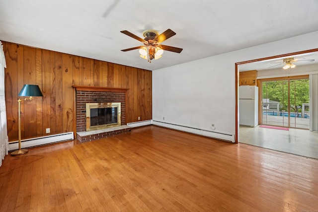 413 Hickory Hill Rd, Thomaston, CT 06787 - unfurnished living room with ceiling fan, baseboard heating, a baseboard heating unit, wood finished floors, and wooden walls