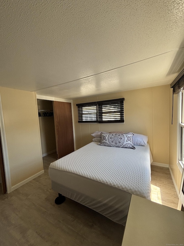 1012 Old Colony Rd Lot 85, Meriden, CT 06451 - bedroom featuring wood finished floors, a textured ceiling, a closet, and baseboards