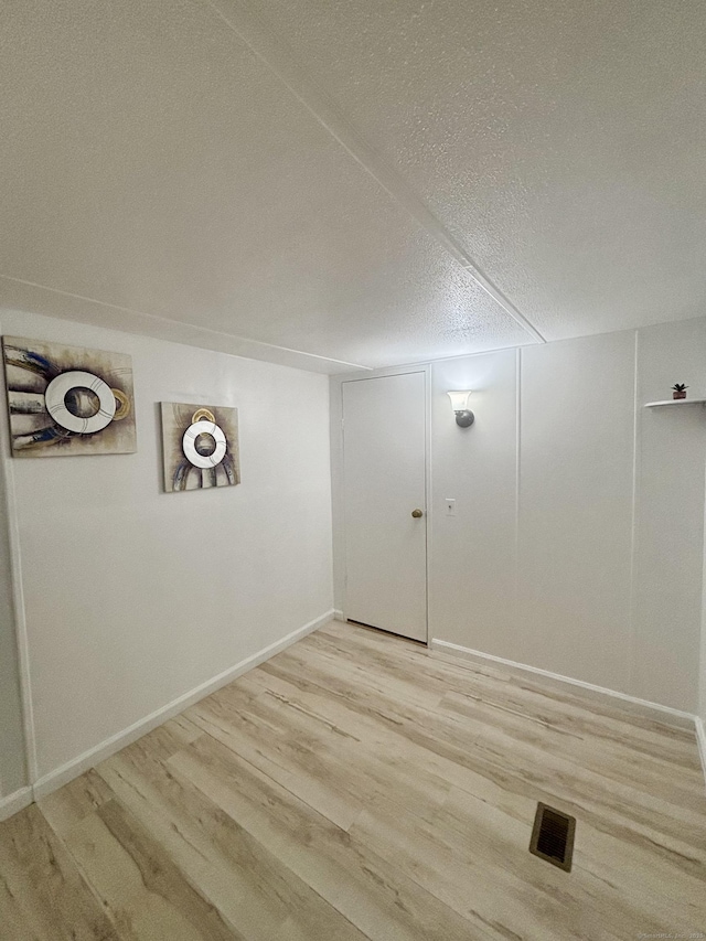 1012 Old Colony Rd Lot 85, Meriden, CT 06451 - laundry area featuring light wood-style flooring and a textured ceiling