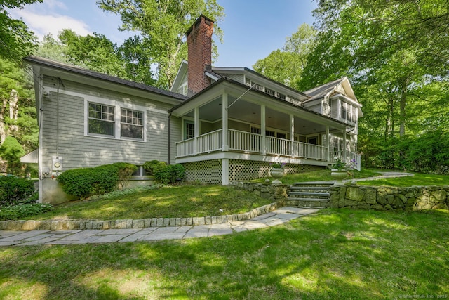 66 Saunders Dr, Wilton, CT 06897 - view of front of property with covered porch, a chimney, and a front yard