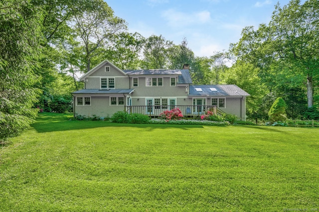 66 Saunders Dr, Wilton, CT 06897 - rear view of property featuring a chimney, a wooden deck, a yard, and view of scattered trees