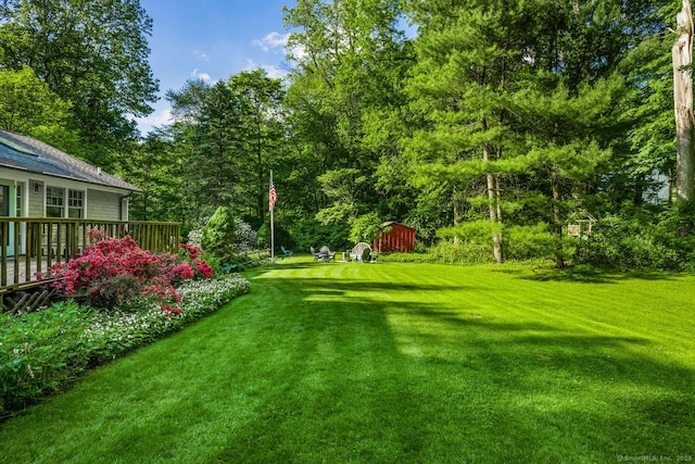 66 Saunders Dr, Wilton, CT 06897 - view of green lawn featuring a shed and a wooden deck